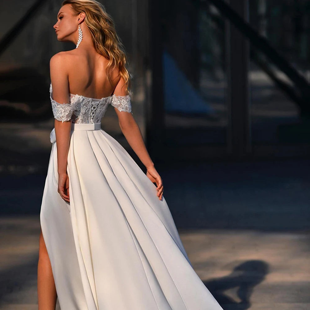 Introducing the elegant and timeless Robe Léonie. This stunning bridal gown features intricate sequins and delicate lace appliques, designed to make you shine on your special day. With a side split design, this dress adds a modern touch to a classic silhouette. Make a statement with Robe Léonie.