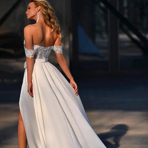 Introducing the elegant and timeless Robe Léonie. This stunning bridal gown features intricate sequins and delicate lace appliques, designed to make you shine on your special day. With a side split design, this dress adds a modern touch to a classic silhouette. Make a statement with Robe Léonie.