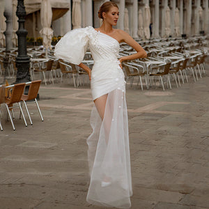 This eye-catching Mimi robe is sure to make you the center of attention at any bridal event! With its mini length, one shoulder style, and taffeta fabric it exudes sophisticated elegance. The sheath cut with its 3D flowers and pearls provide a unique look that packs a big fashion statement. And the short puffy sleeves add a playful touch to complete the look - swoon-worthy!