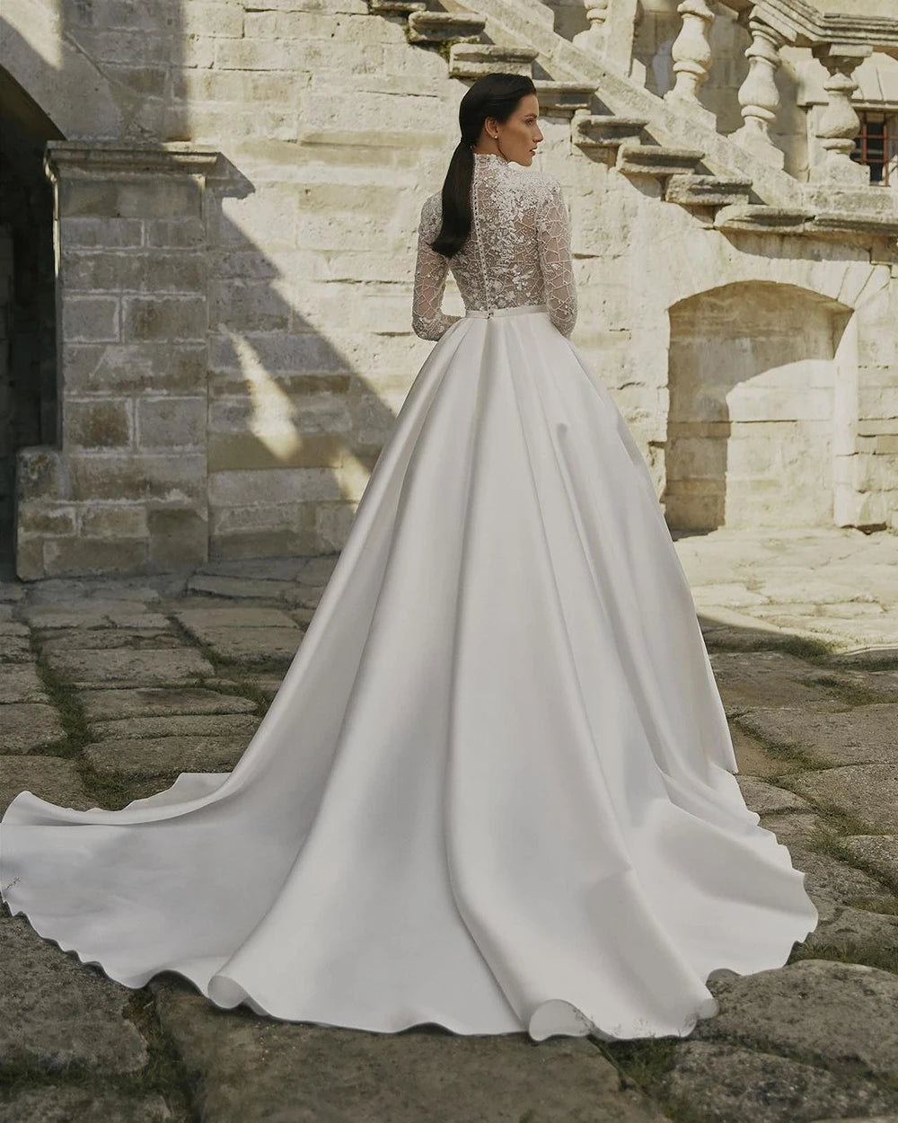 Indulge in timeless elegance with our Robe Prisca. This luxury boho wedding dress features a high neck, long sleeves, and intricate lace and sequin details. Made with satin, it's perfect for a sophisticated bridal look that will make you feel like a work of art.