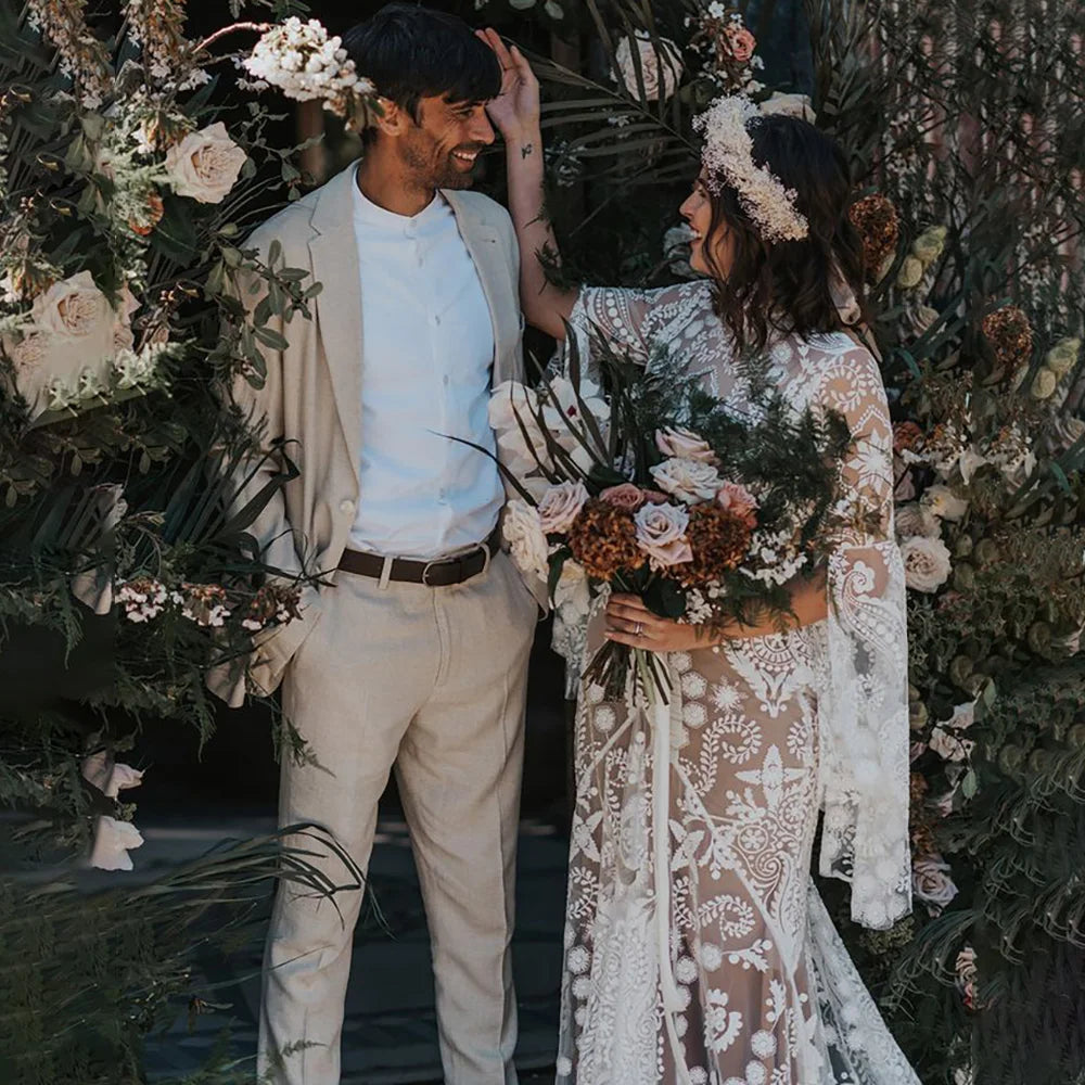 Expertly crafted for the modern and elegant bride, the Robe Anaise features delicate lace detailing and a sleek, form-fitting silhouette. Its long batwing sleeves and high neck add a touch of bohemian flair, while the custom made double slip with slit ensures comfort and movement on the big day. Complete your bridal look with this two-piece, backless sheath gown.