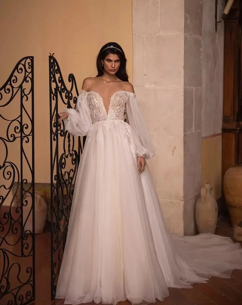 Introducing the Robe Marlene - the perfect bridal gown for those who want to make a statement! With its long full puff sleeves and A-line silhouette, this gown will make any bride feel like a fairy tale princess.