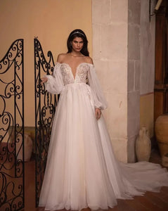 Introducing the Robe Marlene - the perfect bridal gown for those who want to make a statement! With its long full puff sleeves and A-line silhouette, this gown will make any bride feel like a fairy tale princess.