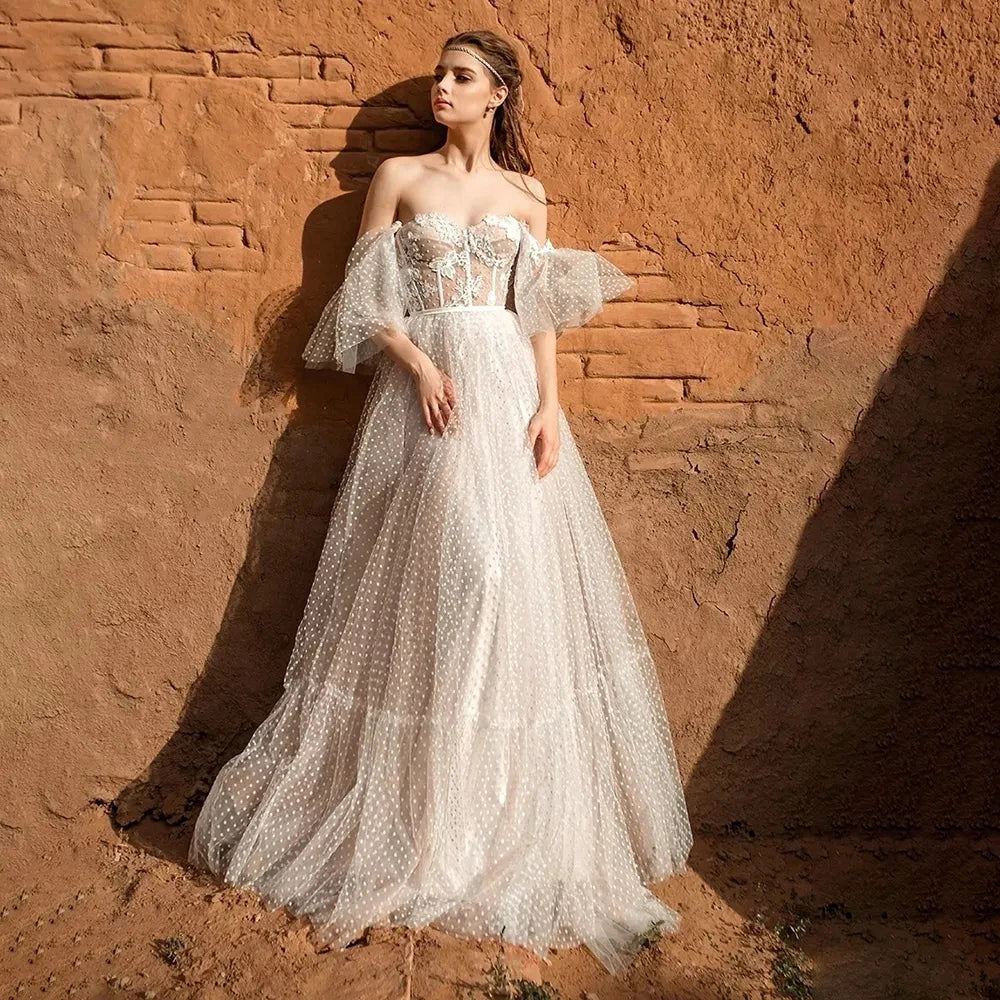 Indulge in the exquisite elegance of our Bohemian A Line Wedding Dress - Dress Violet. The beautiful off shoulder design and the fluffy sleeves will make you feel like a romantic goddess, while the elegant lace applique and backless style add a touch of sensuality. Say "I do" in style with this eye-catching dress that will make you feel confident and stunning on your special day.