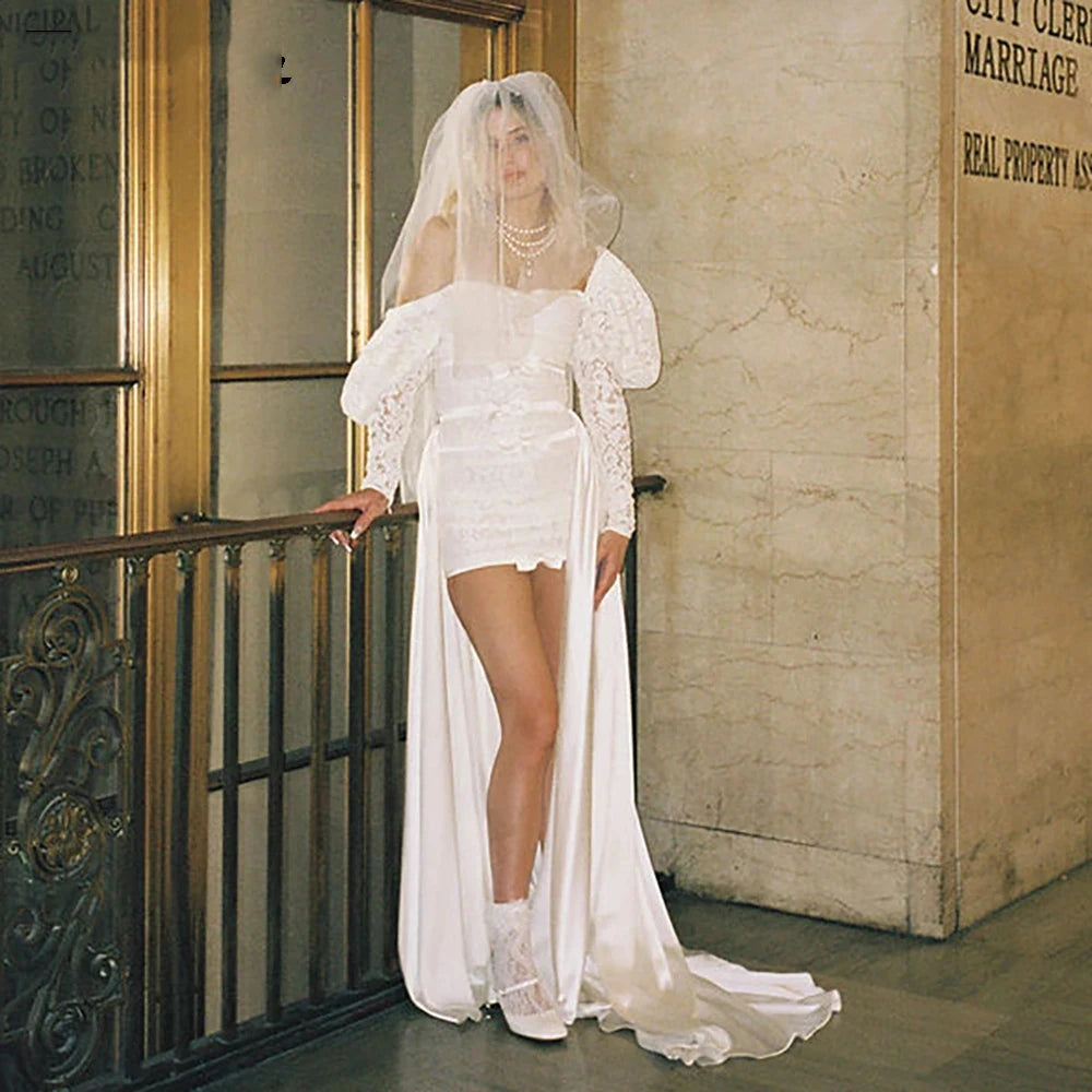 Indulge in elegance with Dress Mia: a stunning wedding dress with a sweet square neck, long fluffy sleeves, and custom-made ruching. The A-line silhouette and shirred straps create a flattering shape, while the luxurious satin fabric adds a touch of sophistication. Make your special day even more memorable with this exclusive dress.