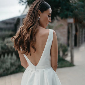 Indulge in the luxurious simplicity of the Robe Aude. Handcrafted from the finest satin, this custom-made wedding dress features a high split and open back, adding a touch of sensuality to its minimalist design. Ruched details complete the look, creating a luxe and elegant dress for your special day.