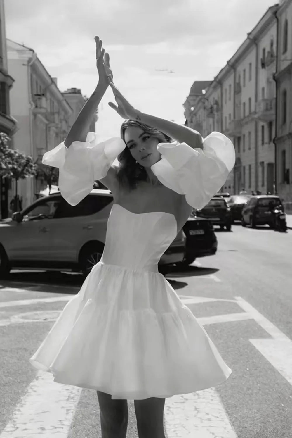 Get ready to stun on your wedding day with the Robe Sherry! This mini wedding dress is perfect for the modern bride, featuring a sweetheart neckline, detachable sleeves, and a boning corset for a flattering fit. Made with luxurious satin, this bridal gown will have you walking down the aisle in style.