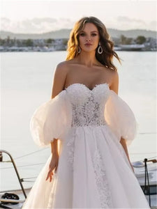 Elevate your special day with our Robe Rene, a luxurious lace ball gown that exudes elegance and sophistication. The off-shoulder design adds a touch of romance, making you feel like a modern-day princess. Perfect for a wedding or any lavish event. Experience the ultimate in style and grace with our Robe Rene.