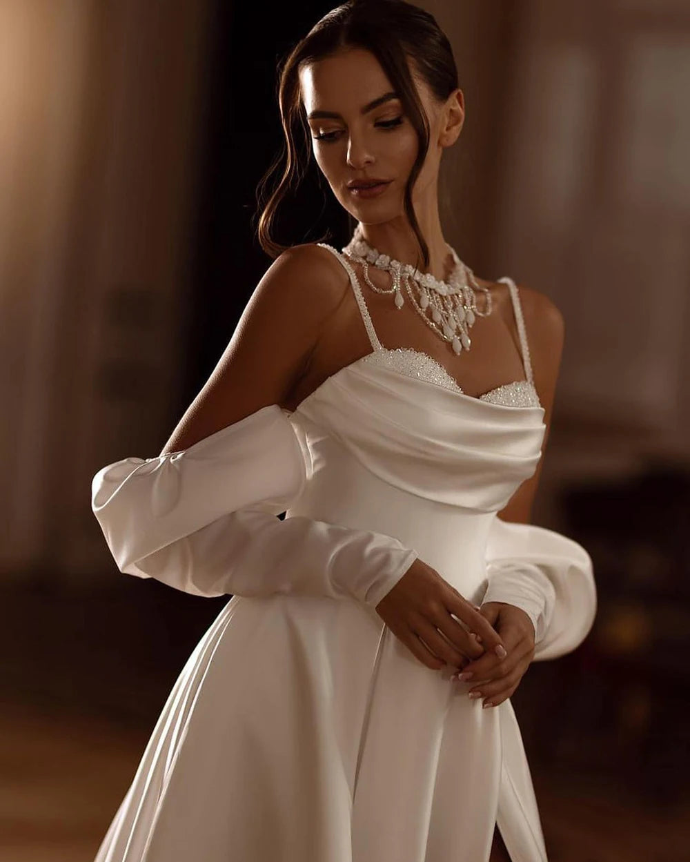 This elegant beach boho wedding dress, known as the Robe Arlette, is perfect for the modern, chic bride. With a sweetheart neckline, intricate bead and sequin detailing, and flattering pleats, this dress exudes grace and sophistication. Make a statement on your special day with this stunning dress.