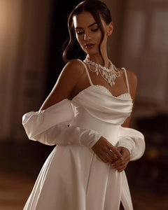 This elegant beach boho wedding dress, known as the Robe Arlette, is perfect for the modern, chic bride. With a sweetheart neckline, intricate bead and sequin detailing, and flattering pleats, this dress exudes grace and sophistication. Make a statement on your special day with this stunning dress.