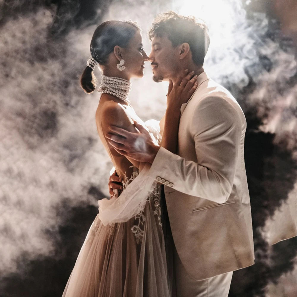 Elevate your wedding day with the Robe Satine, designed with seduction in mind. The off shoulder, high split design is delicately adorned with tulle appliques, shirred sleeves, and intricate beading lace. Its silhouette is perfect for maternity photoshoots and will make you feel like a goddess on your special day.
