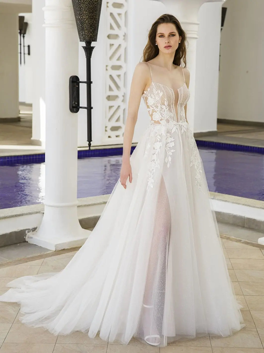 Get ready to stun in our Dress Bella! This A-line bridal gown features a plunging sweetheart neckline, exposed corset, and illusion cut-outs for a daring yet elegant look. The high split adds a touch of drama, making you the show-stopper on your special day.