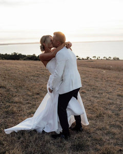 Radiate grace and elegance on your special day with our Dress Caro. This strapless A-line bridal dress is designed to accentuate your curves and leave you feeling like a true bride. With its exquisite craftsmanship and delicate details, this dress is a must-have for any sophisticated woman. Say "I do" in style with our robe de mariée.