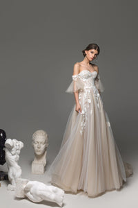 Elevate your bridal look with the Remy Gown. Featuring sweetheart neckline appliques, a chapel train, and a stunning silhouette, it's your chance to make a bold statement on your special day. Dare to be unique!