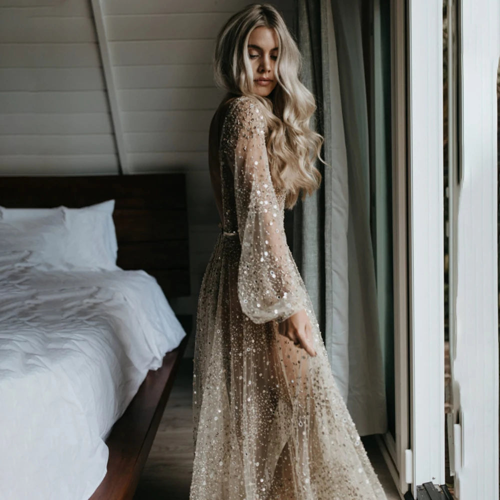 Indulge in the opulence of our Dress Carrie. This luxurious A-line gown boasts intricate beading, a see-through V-neckline, and a backless design. Adorned with sparkling Swarovski crystals and flowing layers of illusion tulle, it's a custom-made masterpiece fit for a bride's most special day.