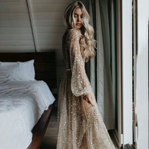 Indulge in the opulence of our Dress Carrie. This luxurious A-line gown boasts intricate beading, a see-through V-neckline, and a backless design. Adorned with sparkling Swarovski crystals and flowing layers of illusion tulle, it's a custom-made masterpiece fit for a bride's most special day.