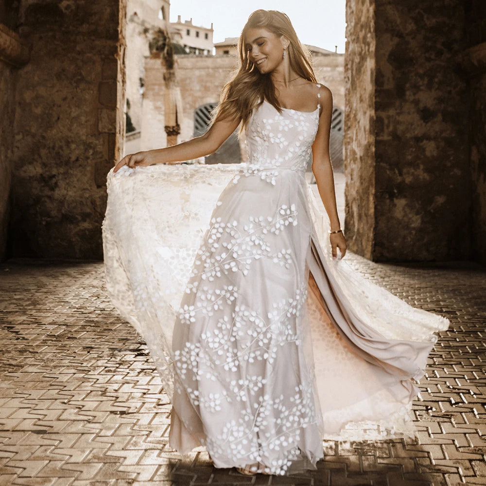 Introducing Robe Bijou - a luxury bridal gown crafted from high quality lace, with a scoop neckline and spaghetti straps. Embroidered tulle adds a stunning touch, with a unique thigh-high split and custom fit. Look and feel your absolute best on your special day!