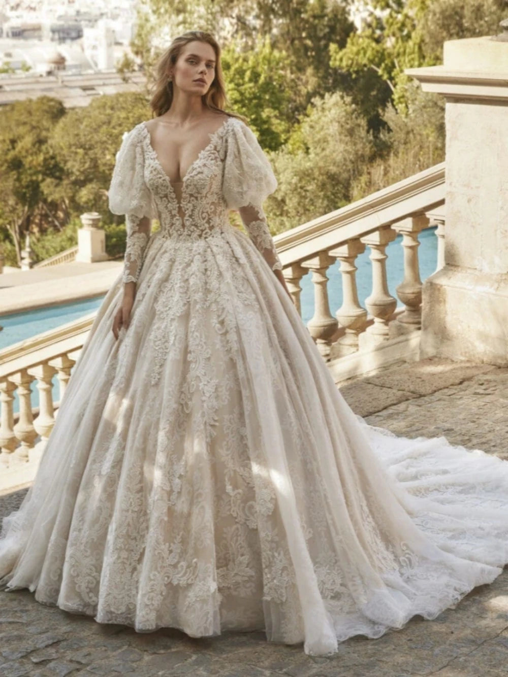 Indulge in pure elegance with our Robe Jadore. This classic applique robe features sparkling beadings and graceful long sleeves, perfect for a romantic bridal look. Embrace the luxurious ball gown silhouette and make a statement on your special day.