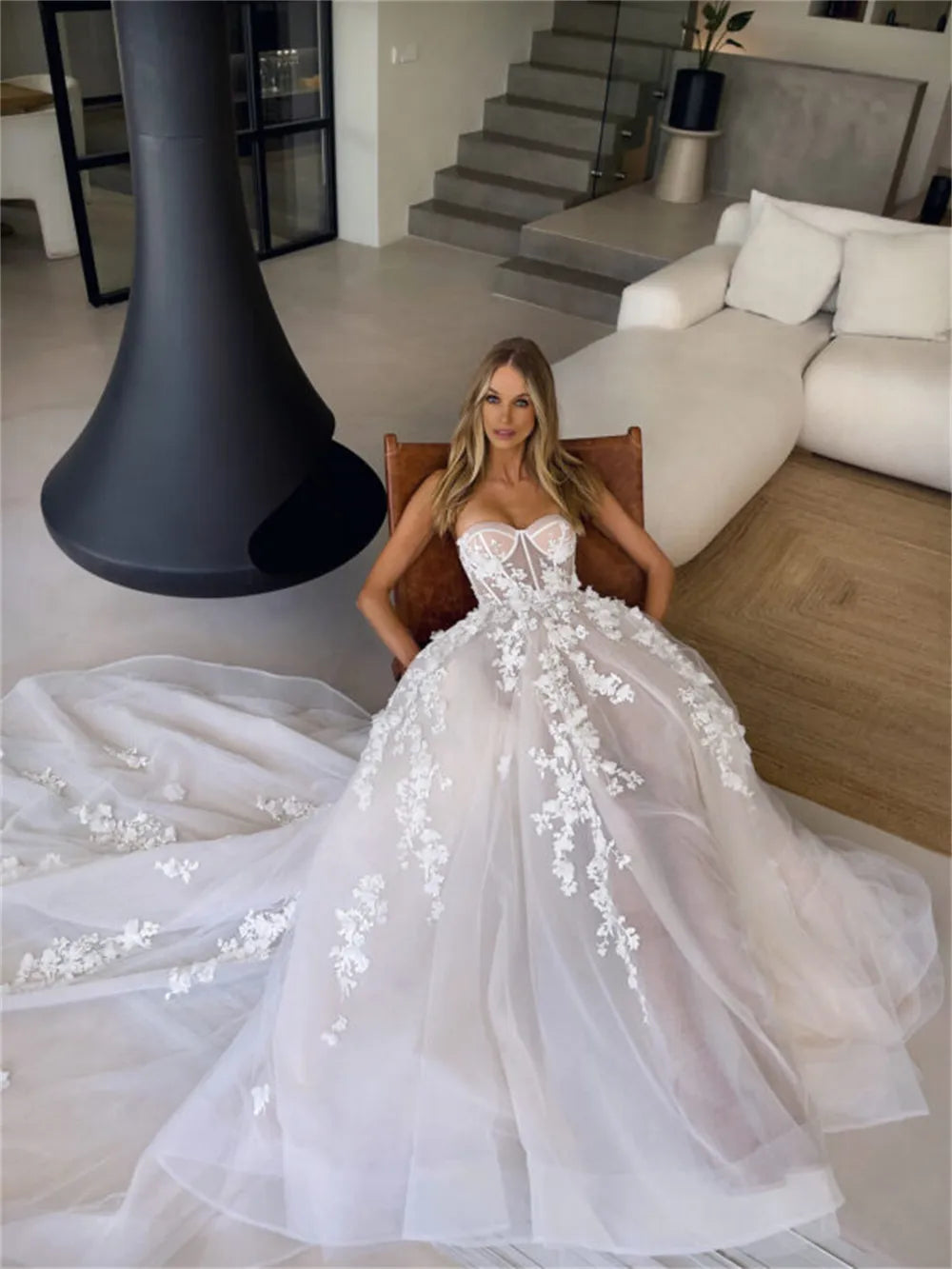 Enhance your special day with our Robe Eva. This stunning wedding dress features a flattering sweetheart neckline and elegant sleeveless design, giving you a timeless A-line silhouette. Adorned with delicate flowers, this bridal gown will make you feel like a beautiful bride on your big day.