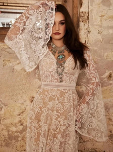 Indulge in the ethereal beauty of our Robe Vivien. This exquisite bridal gown features an empire V-neck, sweep floor length, cut-out open back, and delicate lace detailing. Elegantly crafted for your special day, it exudes grace and sophistication. Feel like a goddess on your wedding day with Robe Vivien.