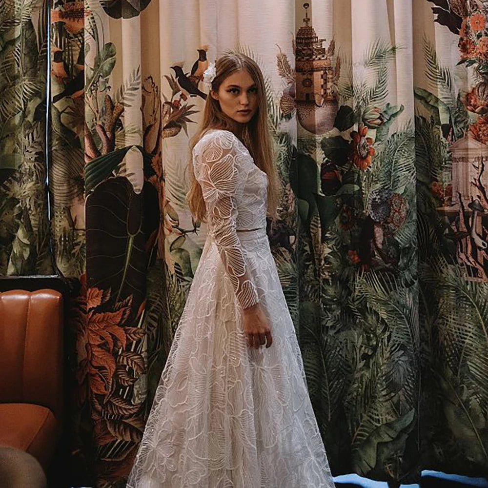 Discover the perfect wedding gown for your special day with Robe Monet's Floral Lace Sequined Square Neck gown. Sheer long sleeves and a low cut two pieces crop top adorn the modern chic look. Plus size design ensures an elegant and stylish fit for every bride. Make your dream come true in this beautiful bridal dress!