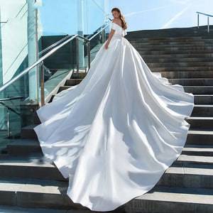 Experience the ultimate in luxury and style with our Robe Victoire. Crafted with elegant matte satin, this ball gown wedding dress will make you feel like royalty on your special day. Its timeless design and impeccable fit will leave you feeling confident and beautiful.