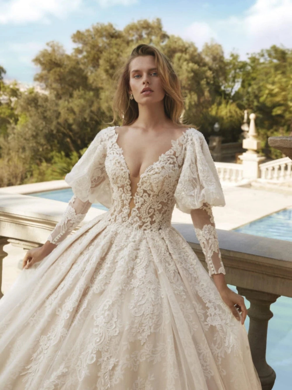 Indulge in pure elegance with our Robe Jadore. This classic applique robe features sparkling beadings and graceful long sleeves, perfect for a romantic bridal look. Embrace the luxurious ball gown silhouette and make a statement on your special day.