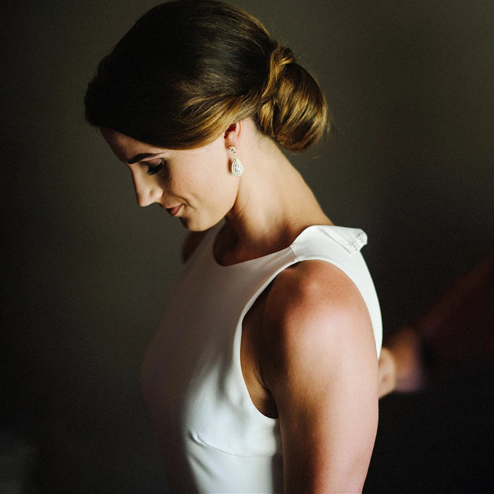 Walk down the aisle in style and comfort with our Dress Ghislaine. This stunning wedding dress features a round neck halter and a beautiful open back design, all made from high-quality satin crepe fabric. Its stretchy sheath silhouette and custom fit make it perfect for plus-size brides looking for a minimalist and elegant look on their special day.