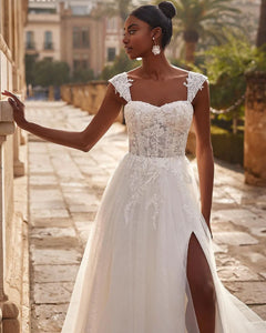 Indulge in the opulent elegance of our Robe Martine. With exquisite appliques and a figure-flattering A Line silhouette, this bridal gown exudes sophistication. The corset backless design adds a touch of sensuality, making it the perfect choice for the boho bride. Embrace luxury and stand out on your special day.