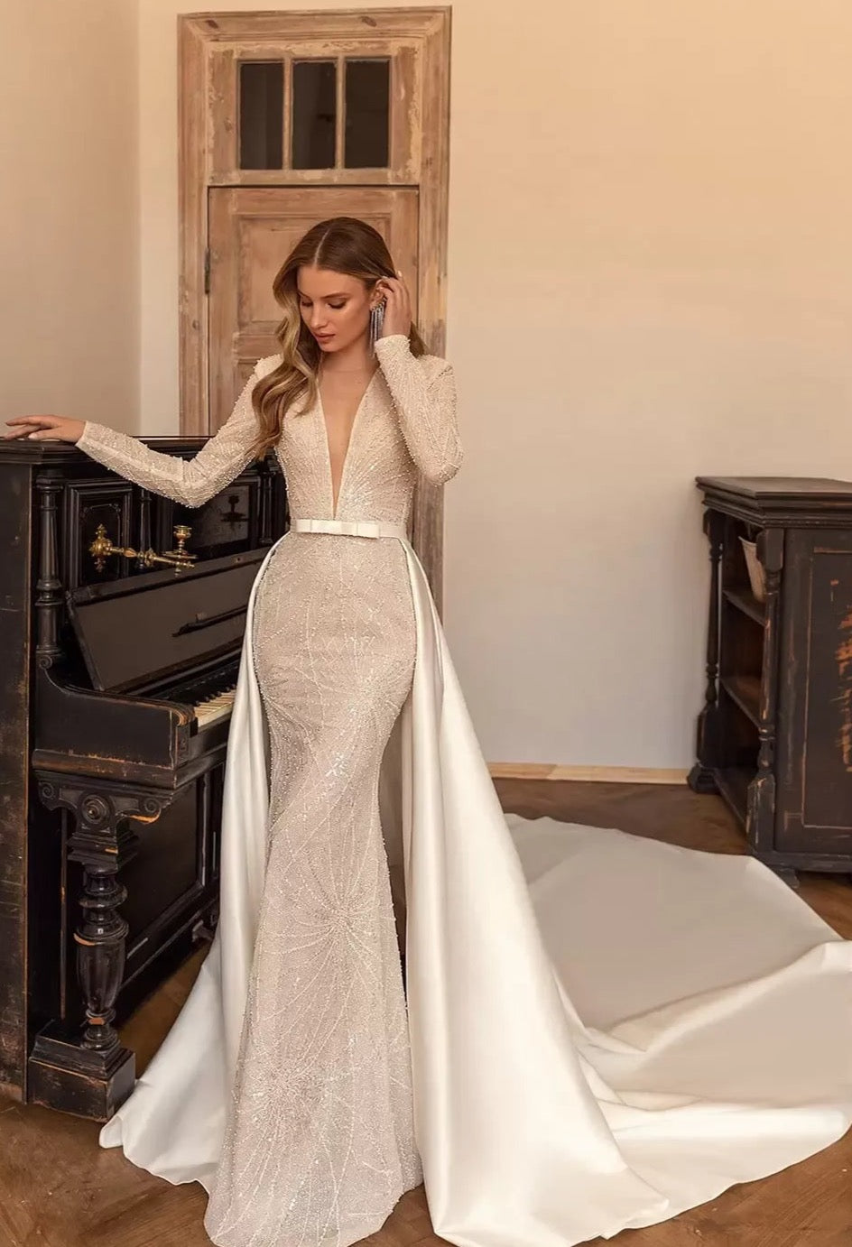 Discover the perfect dress for your special day with Dress Luna! Our stunning wedding gown features a V neckline and two-piece design, creating a sleek and elegant silhouette. The full long sleeves add a touch of sophistication to this luxurious dress. Be a showstopper on your wedding day with Dress Luna.