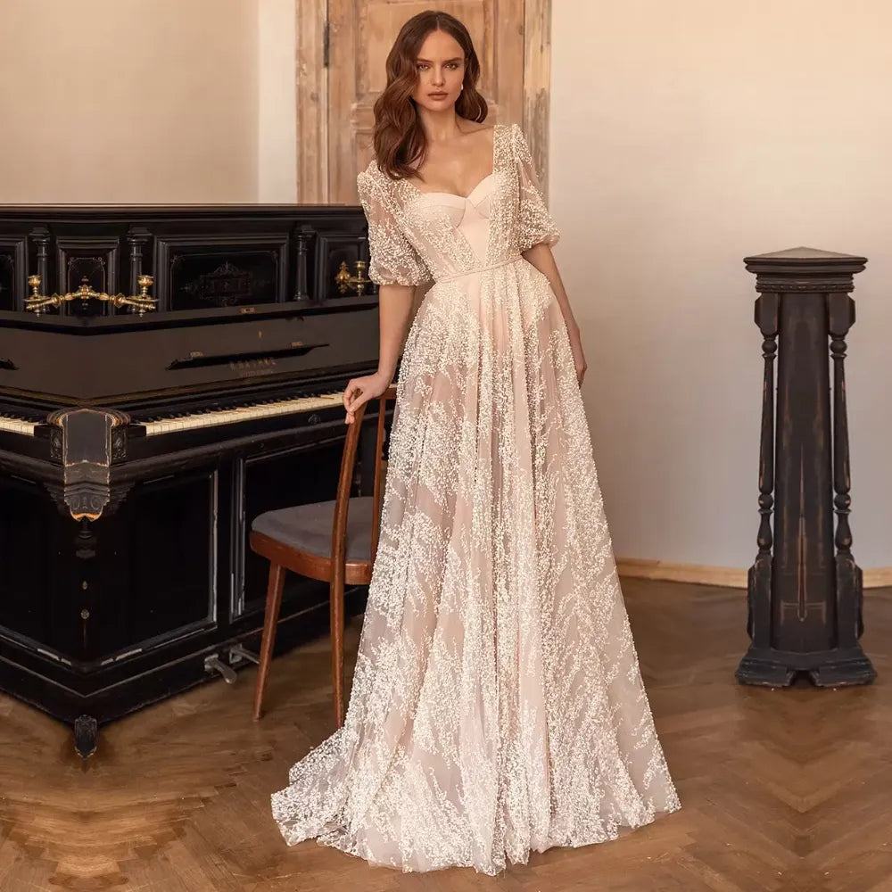 Be the belle of the bridal party in our Robe Sophina. Featuring a lace neckline, short sleeves, and a flattering belt, this gown is the perfect balance of elegance and comfort. Walk down the aisle in style with this must-have for any bride-to-be. (Wedding bells not included!)