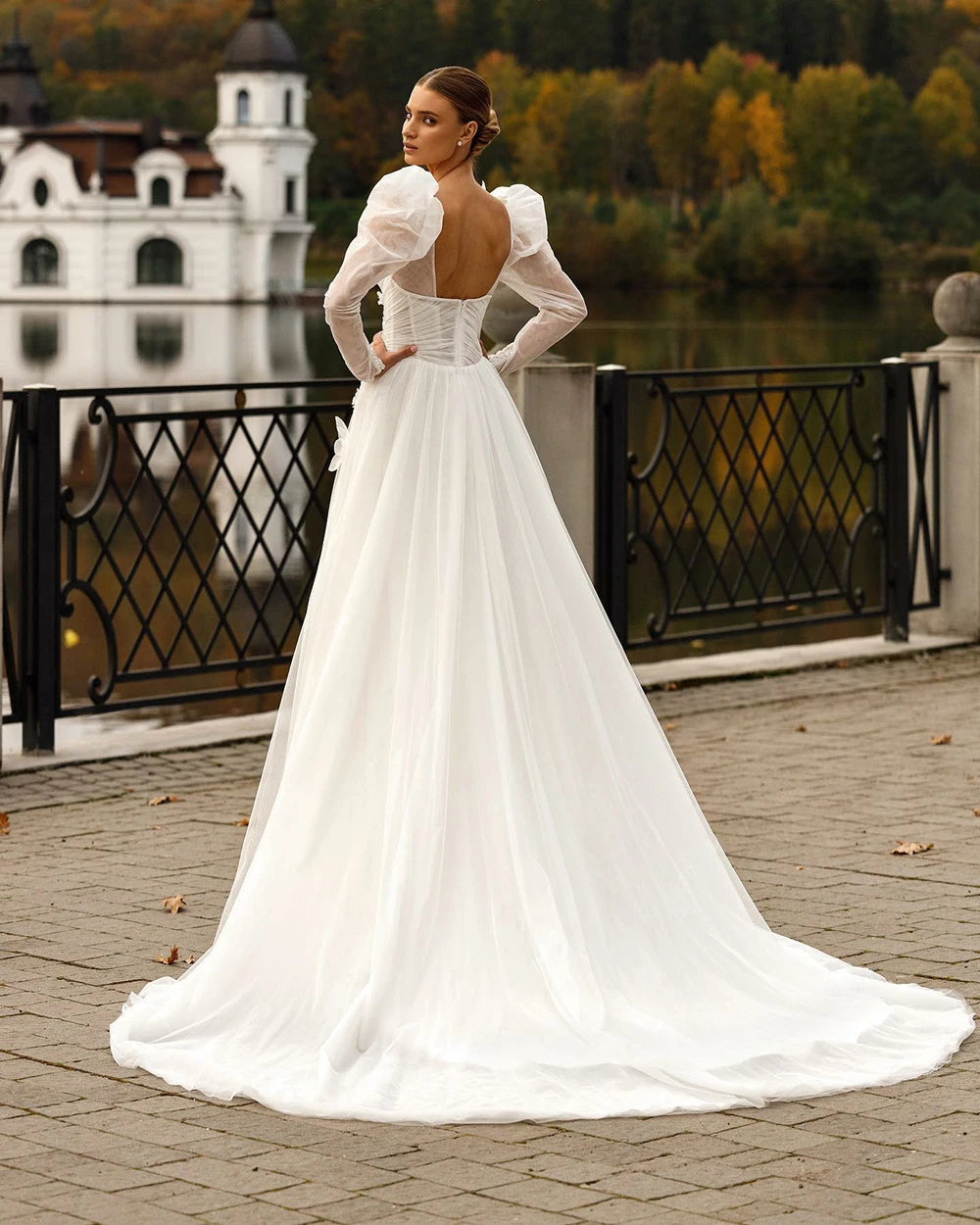 Indulge in luxury with our Robe Sixtine. This elegant Boho wedding dress features delicate lace appliques, an open back, and intricate beading. The long sleeves add a touch of sophistication while the floral details evoke the beauty of a royal wedding. Make a statement on your special day.