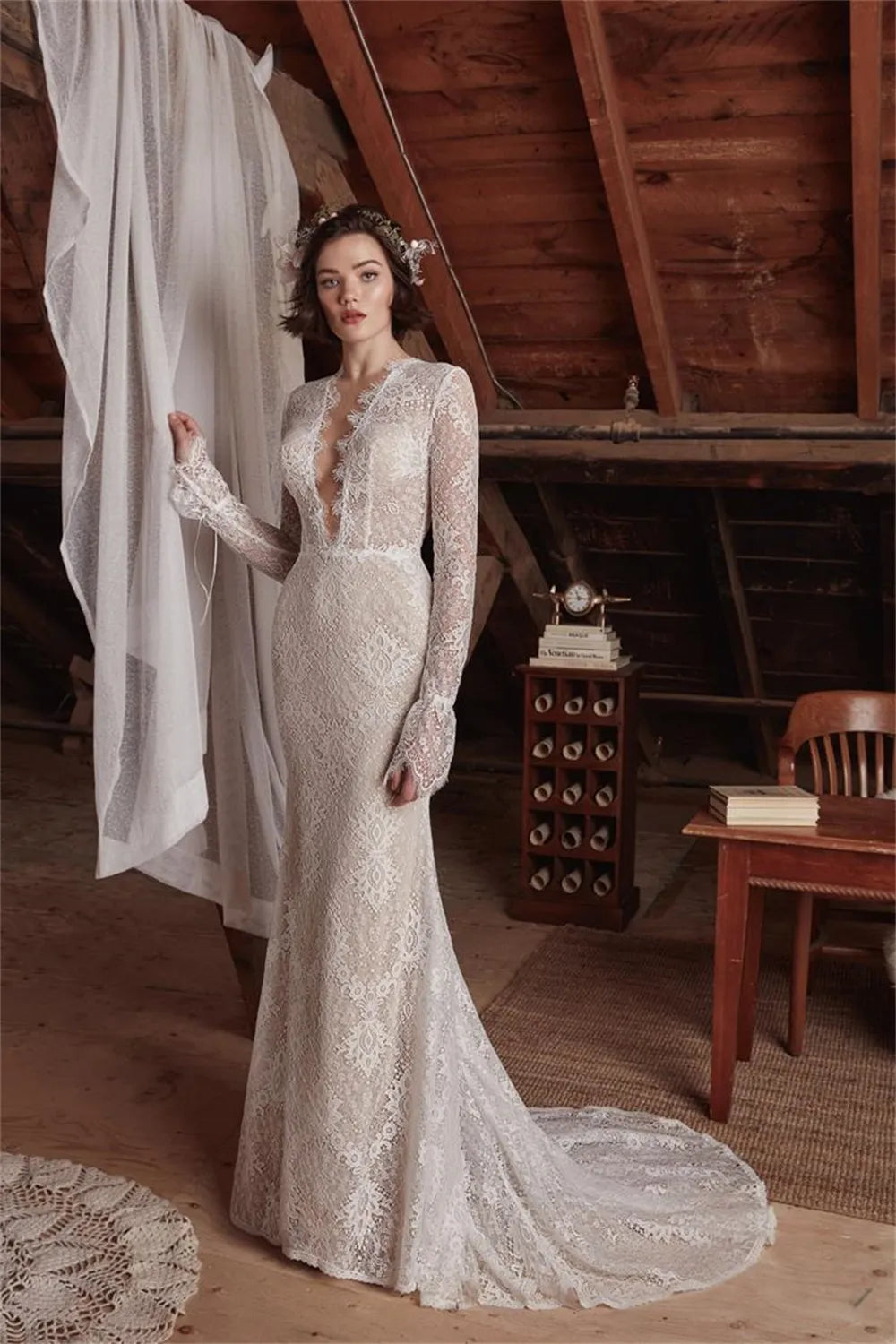 The Aveline wedding dress is perfect for looking beautiful and confident on your special day. The sexy mermaid cut and deep V neckline give you an elegant silhouette while the lace detail and long sleeves add a romantic touch. Create your dream bridal look with this stunning gown.