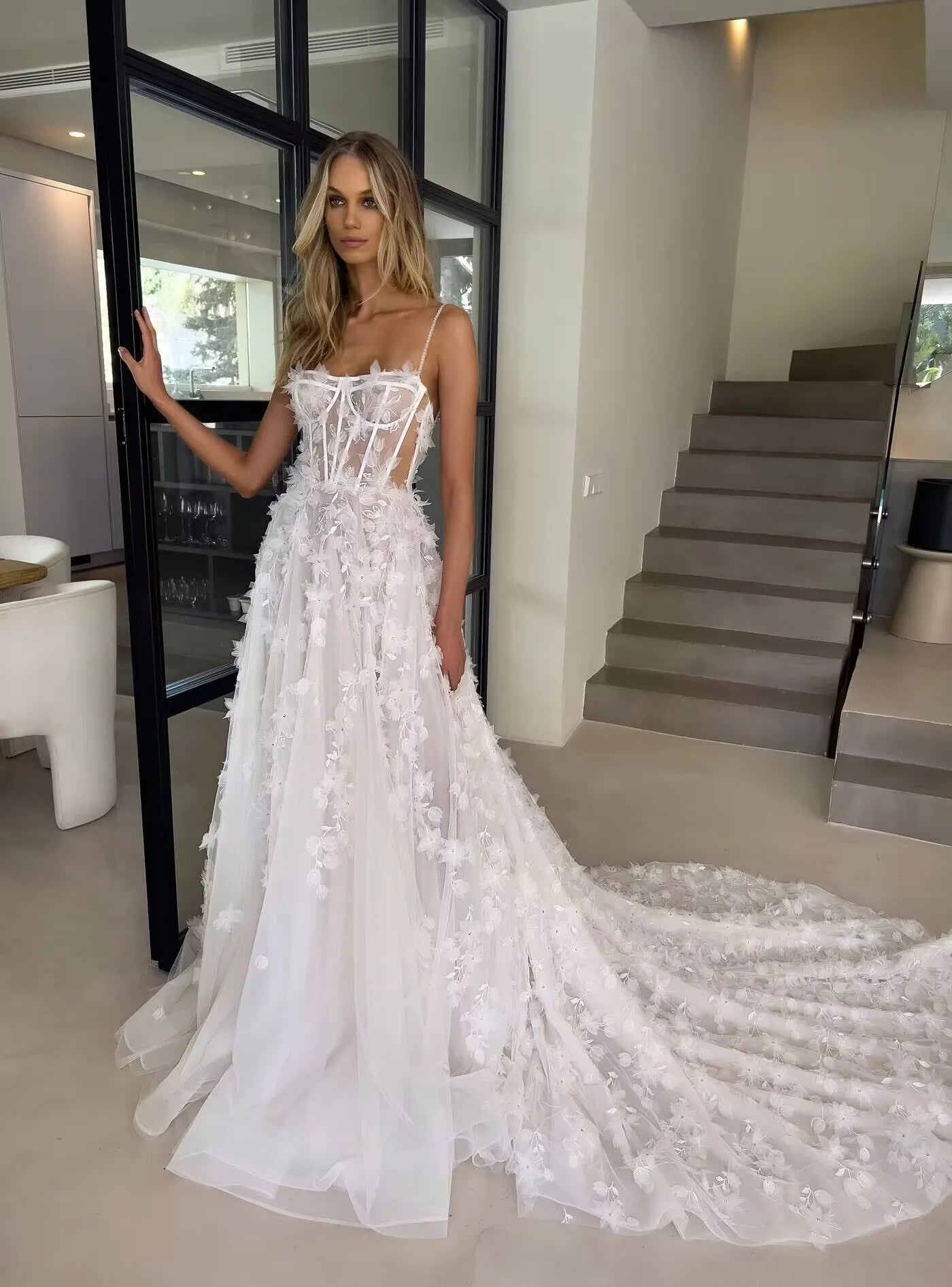 Indulge in pure elegance with our Robe Abrial. This Bohemia wedding dress features delicate 3D flowers, lace appliques, and spaghetti straps for a truly romantic look. Perfect for the modern-day princess bride, this dress will make you feel like royalty on your special day.