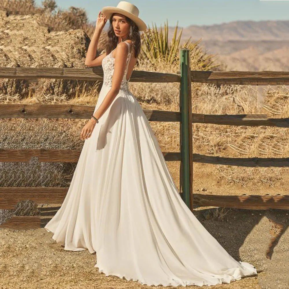The Dress Scarlett is a stunning bohemian wedding dress designed with a V-neck and delicate lace appliques. The A-line silhouette and flowy chiffon fabric add an ethereal touch, while the backless design and button train bring a modern and romantic twist. Perfect for a boho bride looking for a unique and beautiful gown.