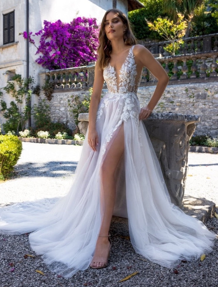 Indulge in the exquisite elegance of the Robe Caroline. This bridal wedding gown features delicate lace details, creating a truly stunning look for any bride. With its timeless design and intricate craftsmanship, this gown is the perfect choice for making everlasting memories on your special day.