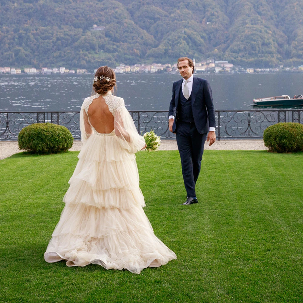 Indulge in sophistication and elegance with our Robe Tali. Featuring long Bishop sleeves, a high neck, and a vintage rustic design, this ball gown is the epitome of luxury. Delicate lace detailing, an open back, and a deep V keyhole add to the allure, making you the center of attention on your special day.