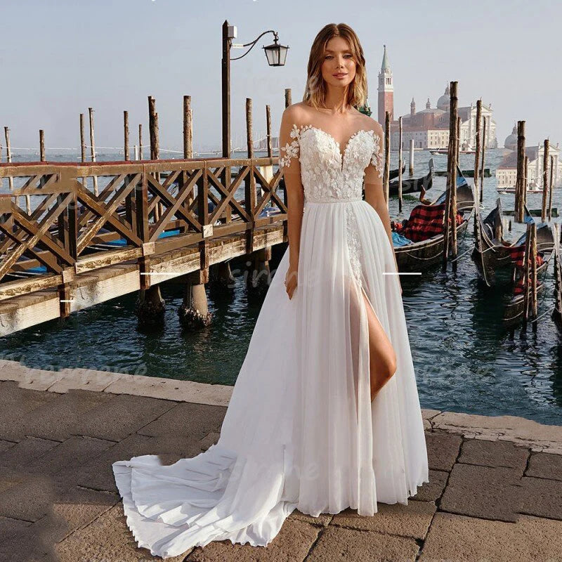 Robe Lilou is a stunning sweetheart A-Line wedding dress featuring a white off the shoulder backless design with exquisite lace applique and a side split. Crafted from the finest chiffon material, it makes a perfect choice for brides who want maximum comfort and elegance.