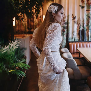 Discover the perfect wedding gown for your special day with Robe Monet's Floral Lace Sequined Square Neck gown. Sheer long sleeves and a low cut two pieces crop top adorn the modern chic look. Plus size design ensures an elegant and stylish fit for every bride. Make your dream come true in this beautiful bridal dress!