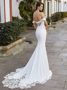 The Robe Nala offers a flattering mermaid silhouette with an off shoulder sweetheart neckline, designed with intricate lace details on a corset bodice. Perfect for brides looking for a versatile and stylish wedding dress.