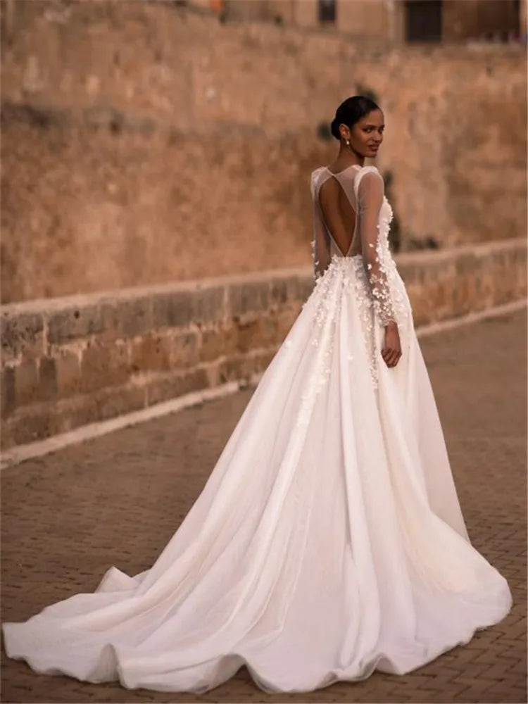 Indulge in timeless elegance with our Robe Nina. Featuring a delicately crafted lace design and long sleeves, this wedding gown is the perfect choice for your special day. Experience the luxury and sophistication of our exclusive collection.