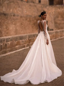 Indulge in timeless elegance with our Robe Nina. Featuring a delicately crafted lace design and long sleeves, this wedding gown is the perfect choice for your special day. Experience the luxury and sophistication of our exclusive collection.