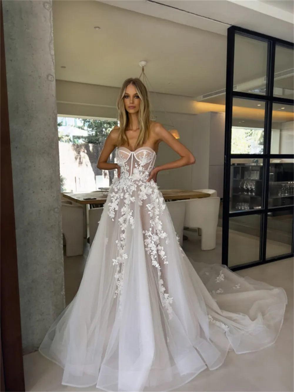 Enhance your special day with our Robe Eva. This stunning wedding dress features a flattering sweetheart neckline and elegant sleeveless design, giving you a timeless A-line silhouette. Adorned with delicate flowers, this bridal gown will make you feel like a beautiful bride on your big day.