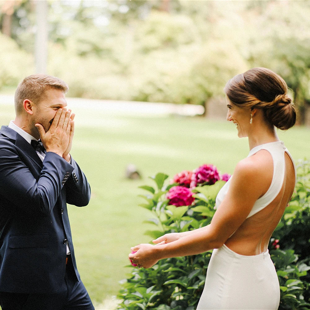 Walk down the aisle in style and comfort with our Dress Ghislaine. This stunning wedding dress features a round neck halter and a beautiful open back design, all made from high-quality satin crepe fabric. Its stretchy sheath silhouette and custom fit make it perfect for plus-size brides looking for a minimalist and elegant look on their special day.
