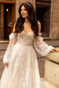 Indulge in luxury with our Robe Rachelle. This elegant wedding dress features delicate lace, long sleeves and a timeless design to make you feel like a true bride. Perfect for the contemporary woman who wants to make a statement on her special day. Step into sophistication with our Robe Rachelle.