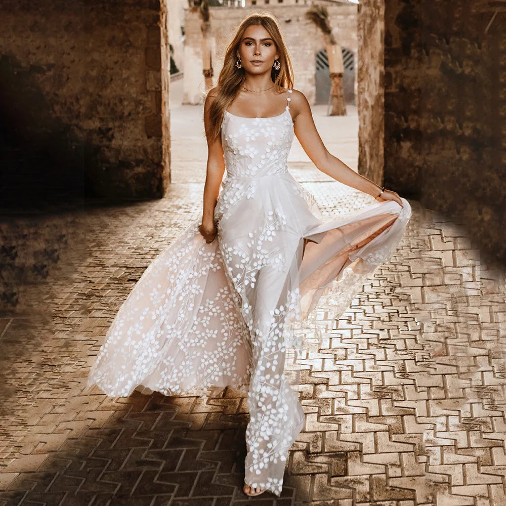 Introducing Robe Bijou - a luxury bridal gown crafted from high quality lace, with a scoop neckline and spaghetti straps. Embroidered tulle adds a stunning touch, with a unique thigh-high split and custom fit. Look and feel your absolute best on your special day!