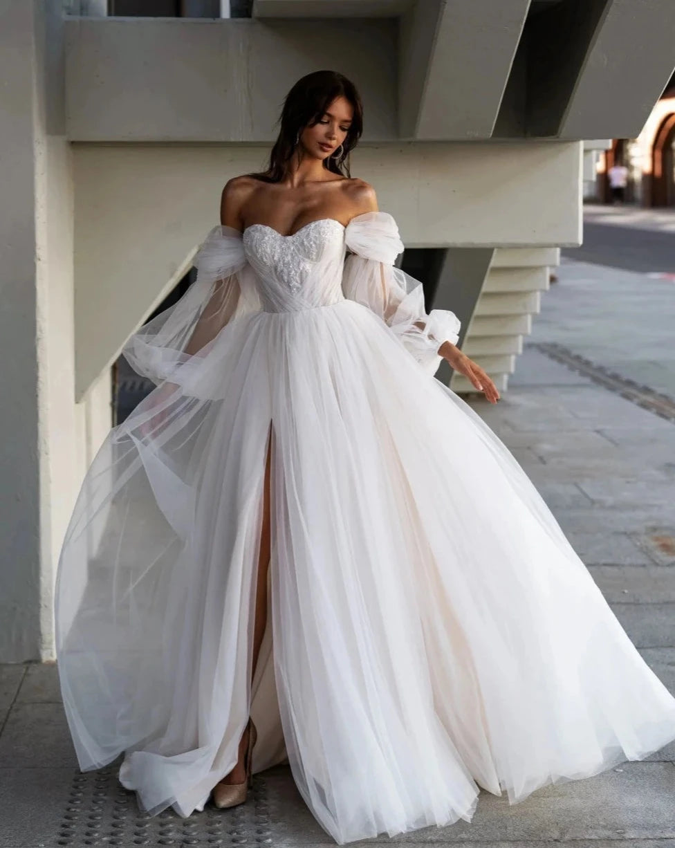 Indulge in pure luxury with our Robe Lova. This elegant off the shoulder wedding dress features sparkling sequins and beads, perfect for the modern bride. Its A-line silhouette flatters all body types, while the pristine white color adds an air of sophistication. Make a statement on your special day with this exclusive piece.