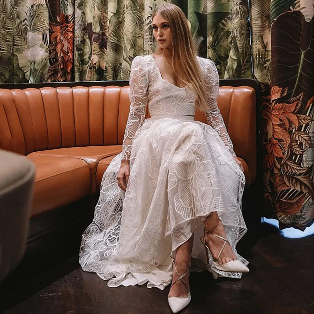 Discover the perfect wedding gown for your special day with Robe Monet's Floral Lace Sequined Square Neck gown. Sheer long sleeves and a low cut two pieces crop top adorn the modern chic look. Plus size design ensures an elegant and stylish fit for every bride. Make your dream come true in this beautiful bridal dress!