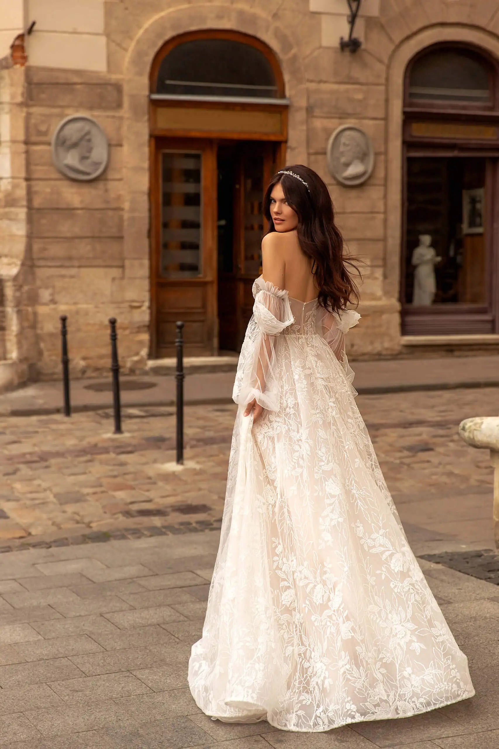 Indulge in luxury with our Robe Rachelle. This elegant wedding dress features delicate lace, long sleeves and a timeless design to make you feel like a true bride. Perfect for the contemporary woman who wants to make a statement on her special day. Step into sophistication with our Robe Rachelle.