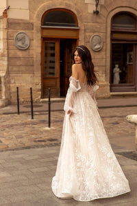 Indulge in luxury with our Robe Rachelle. This elegant wedding dress features delicate lace, long sleeves and a timeless design to make you feel like a true bride. Perfect for the contemporary woman who wants to make a statement on her special day. Step into sophistication with our Robe Rachelle.